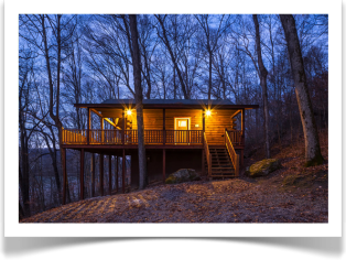 cabin in wooded area with small cabin